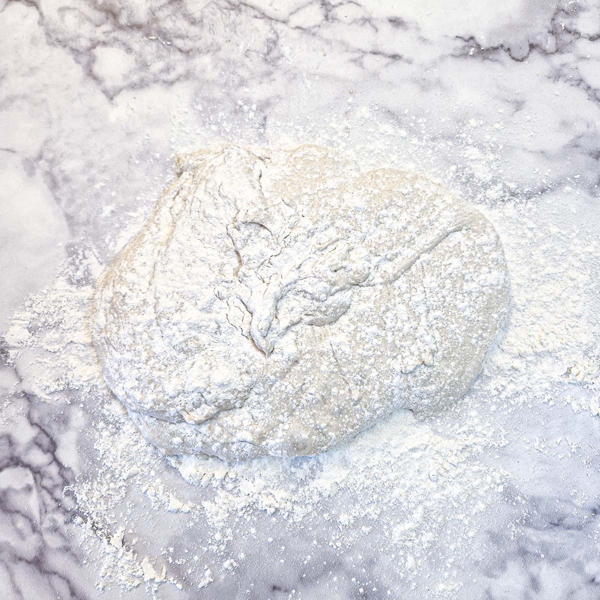 Focaccia dough on a work surface.