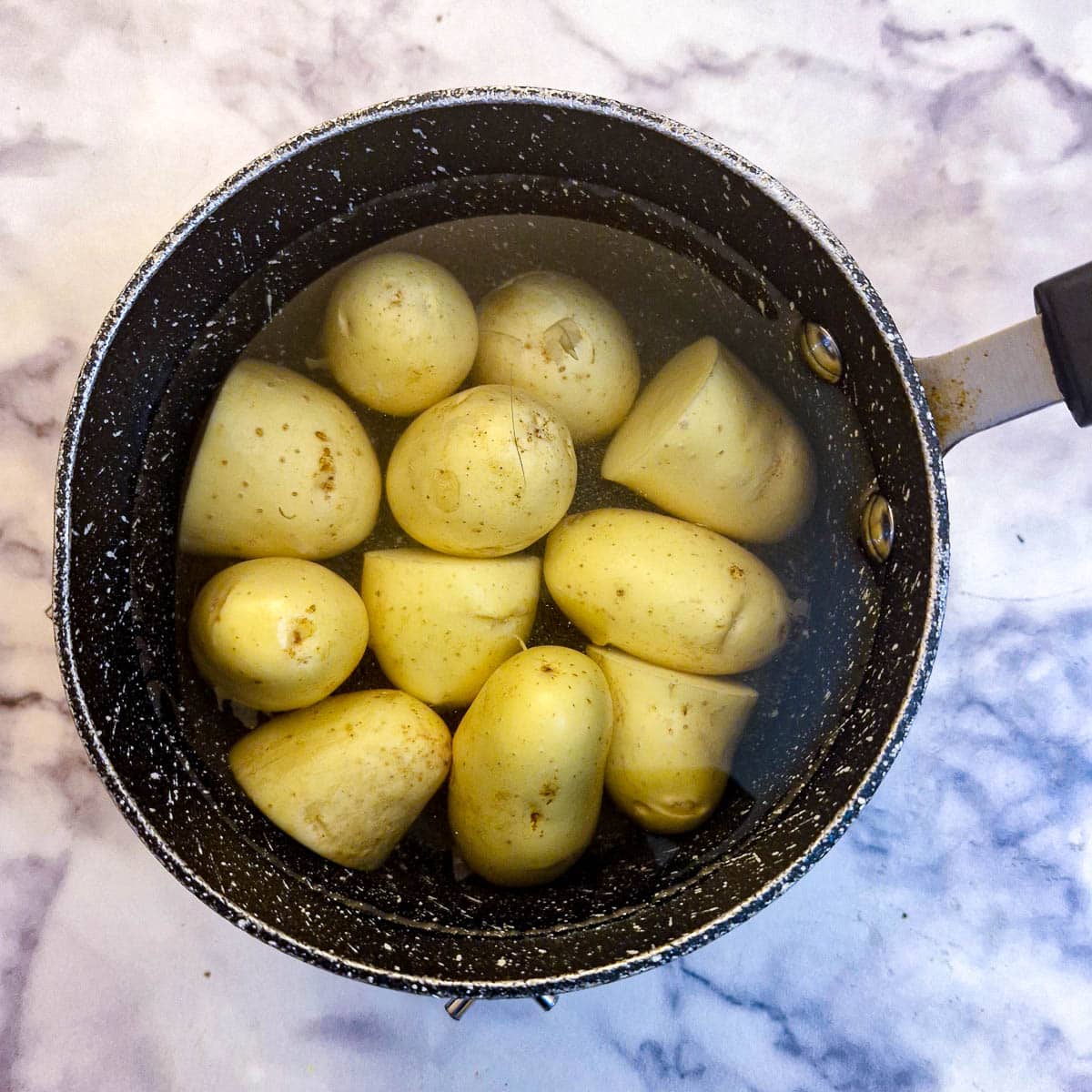 Potatoes in a saucepan of water.