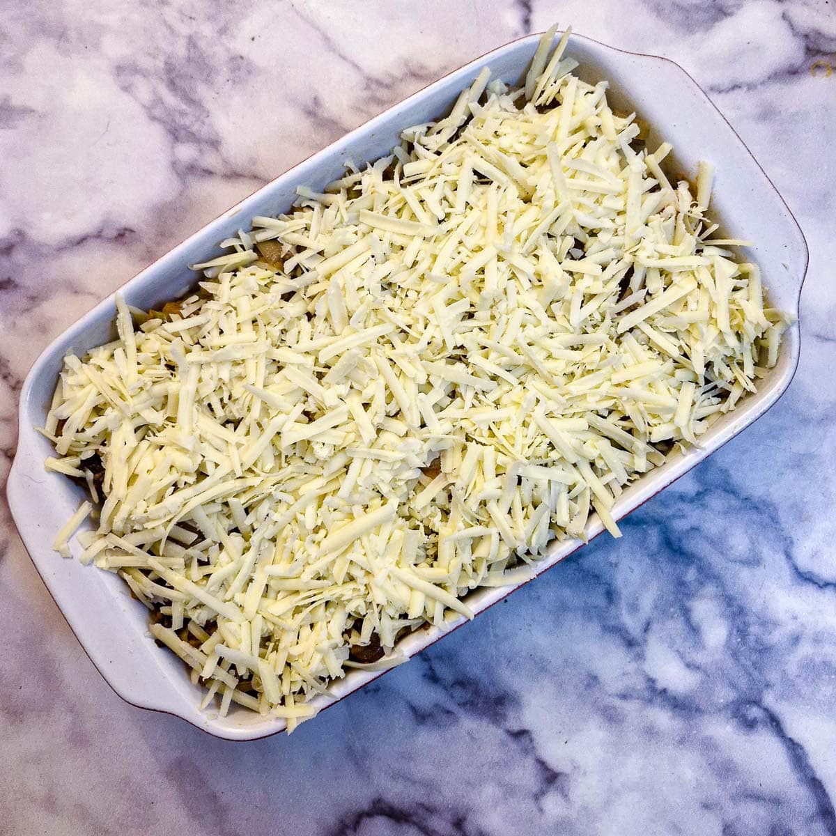 Grated cheese on top of the mince and potato cassrole.