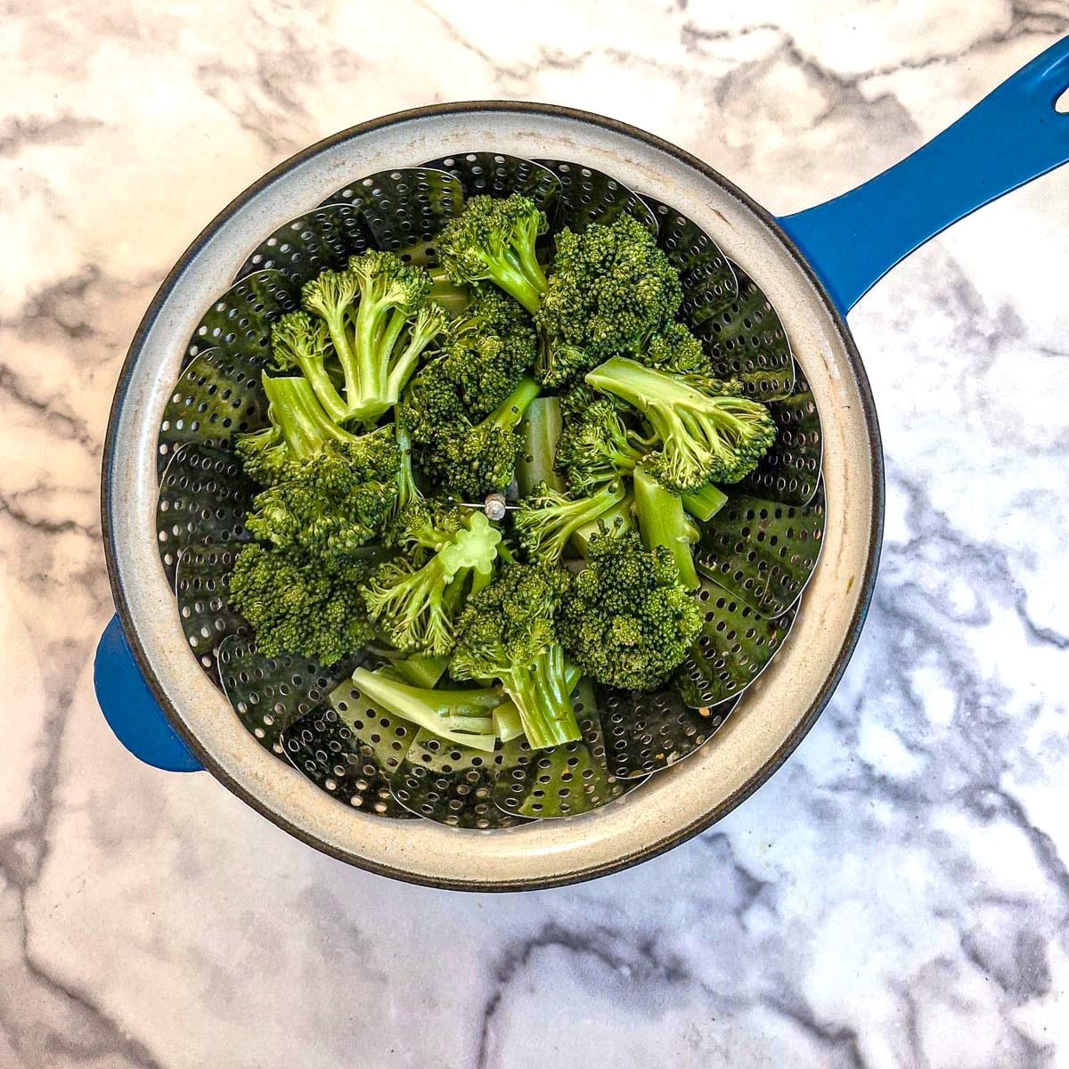 Broccoli florets in a steamer.