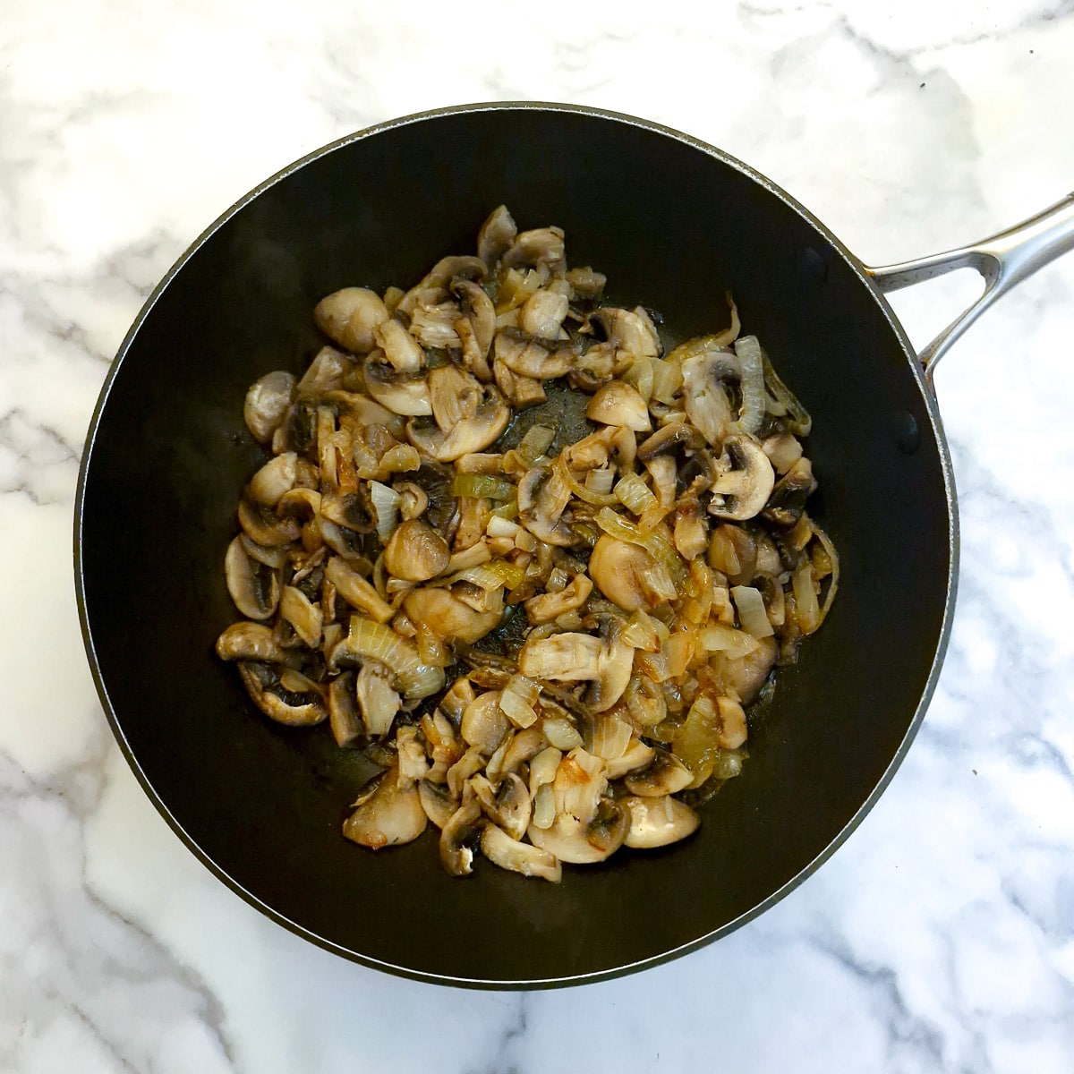 Mushrooms softening with the onions.