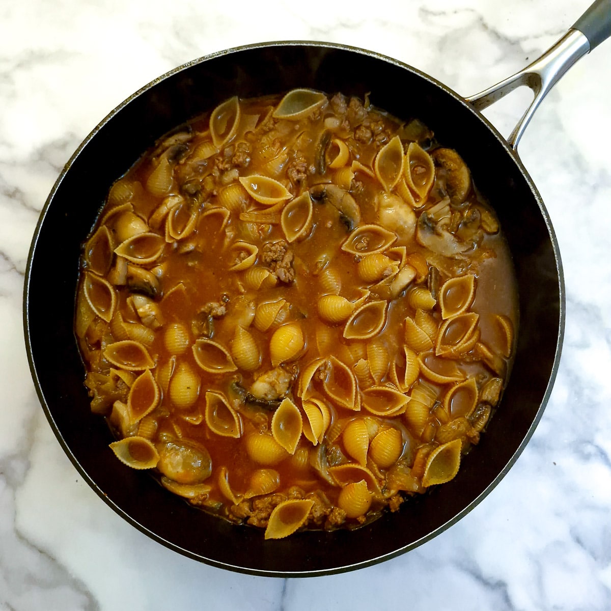 Pasta shells added to the stock.