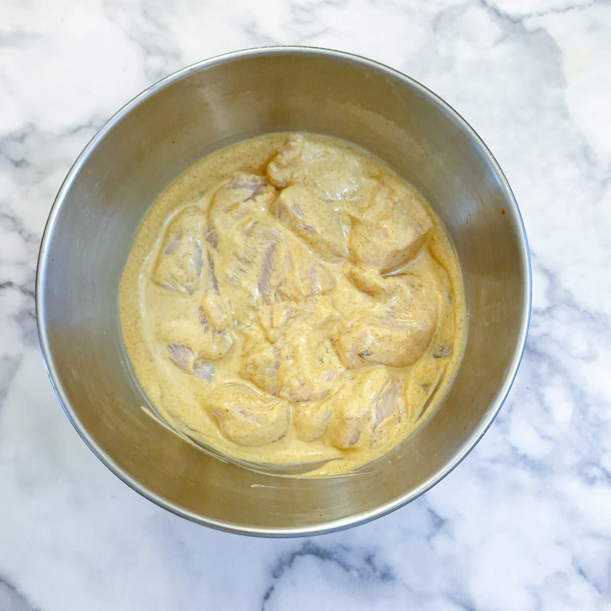 Chicken pieces in the marinade.