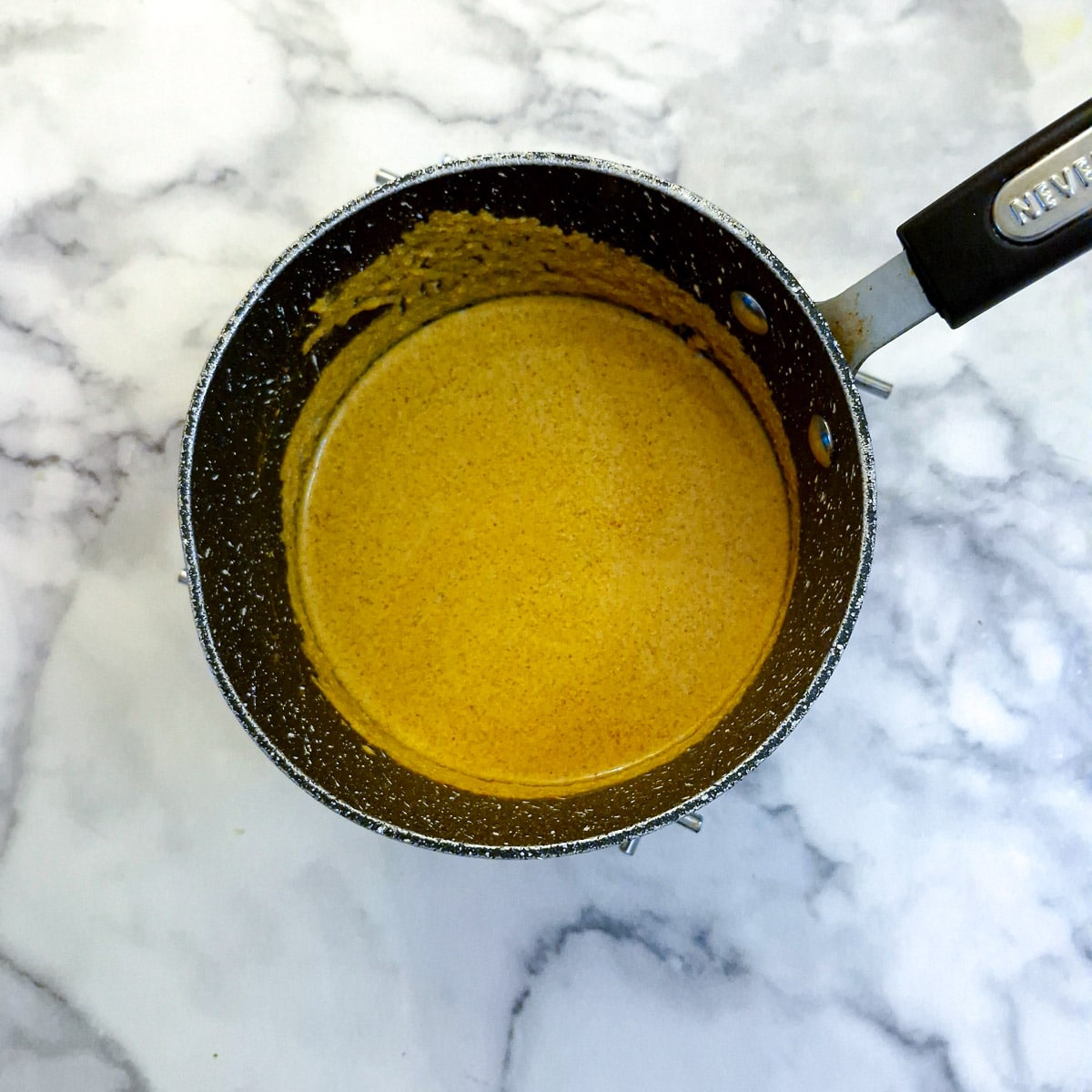 Marinade combined with tomato puree in a small saucepan.