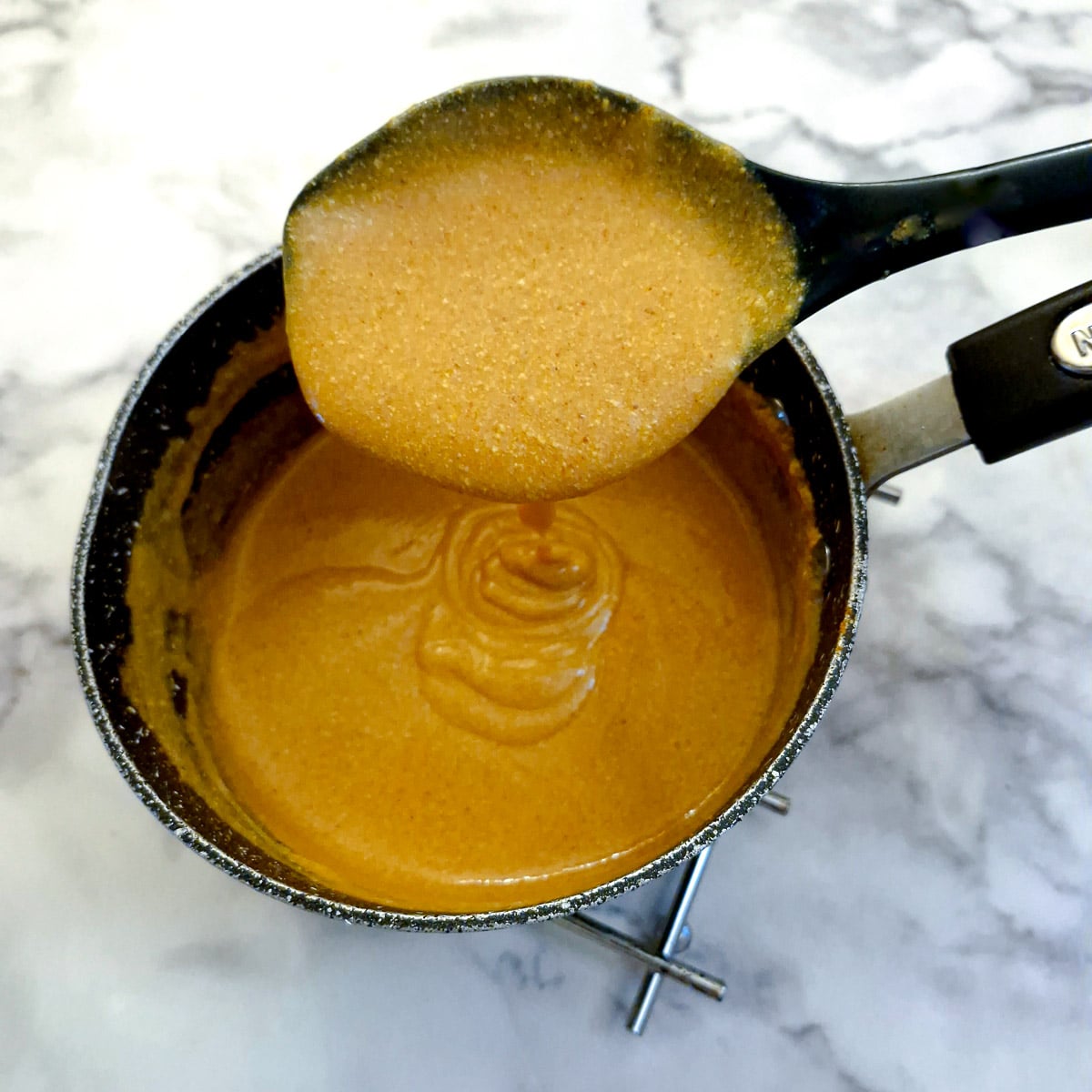 A saucepan of tikka sauce showing the consistency.