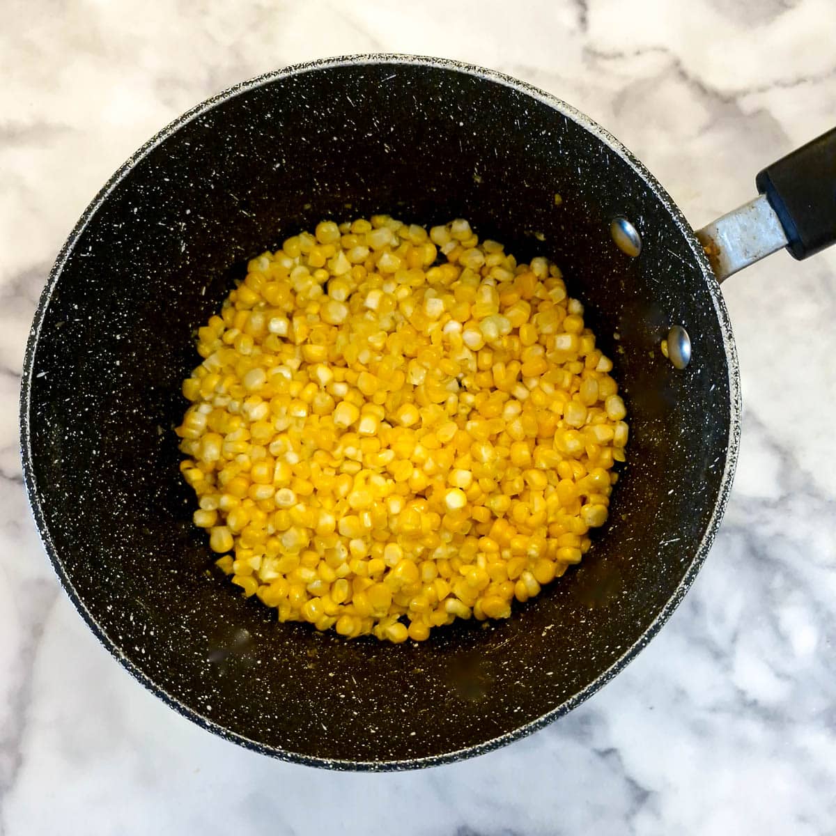 Corn kernels in a saucepan.