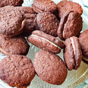 A pile of romany creams on a glass platter.