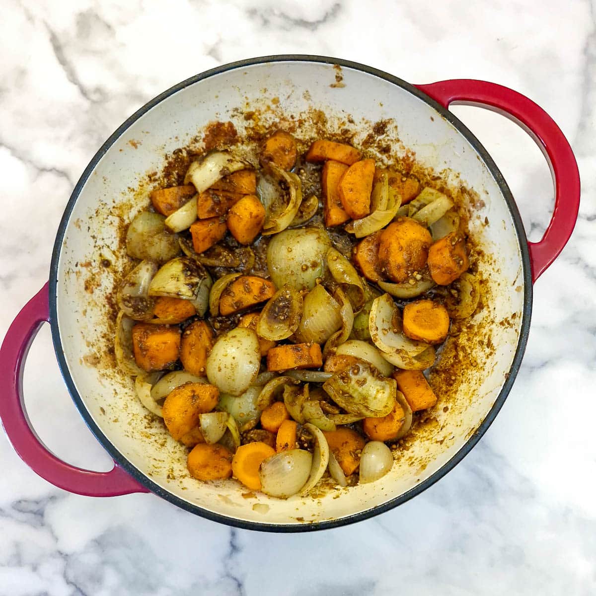 Onions and carrots mixed with curry spices.