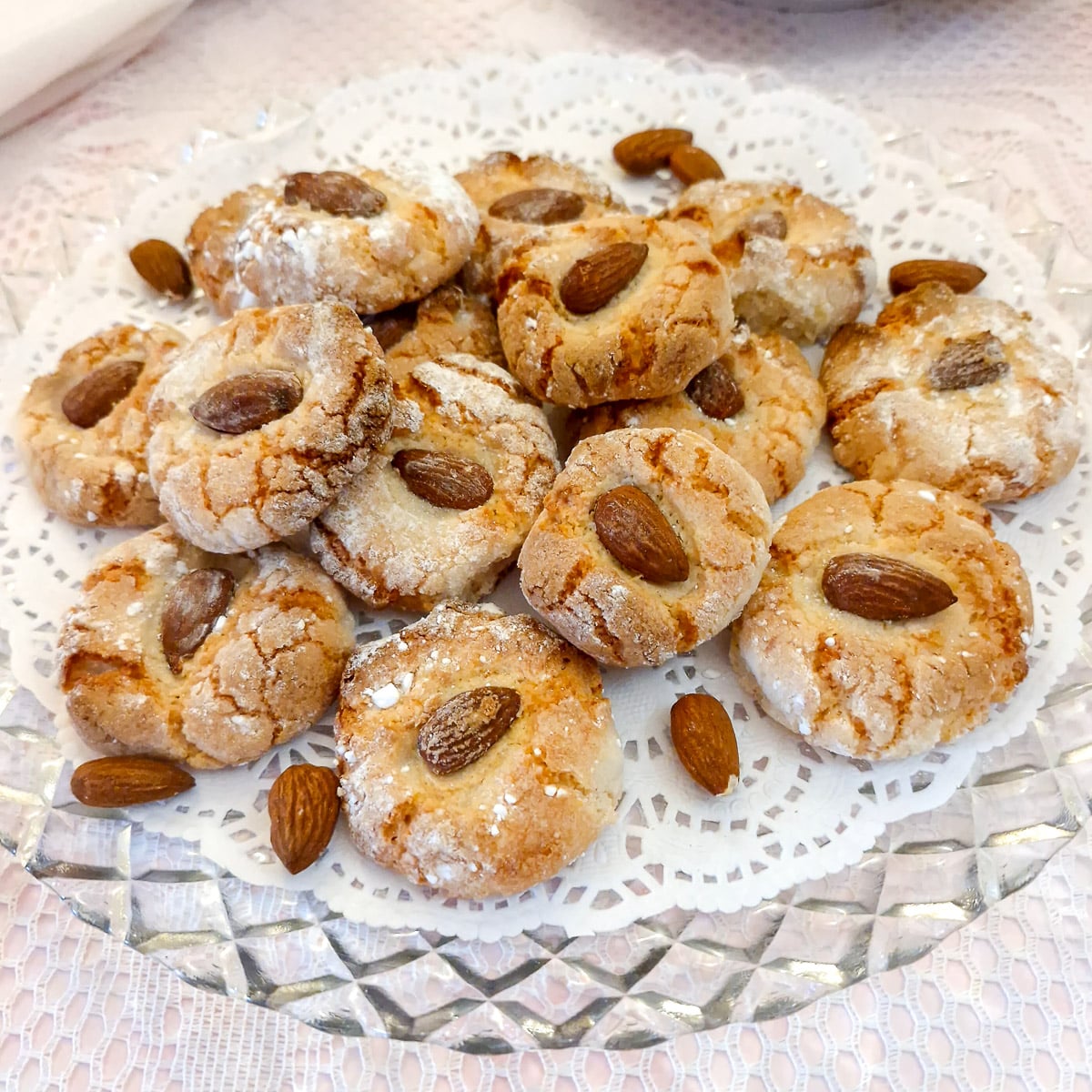 A glass plate with a pile of lemon amaretti biscuits.