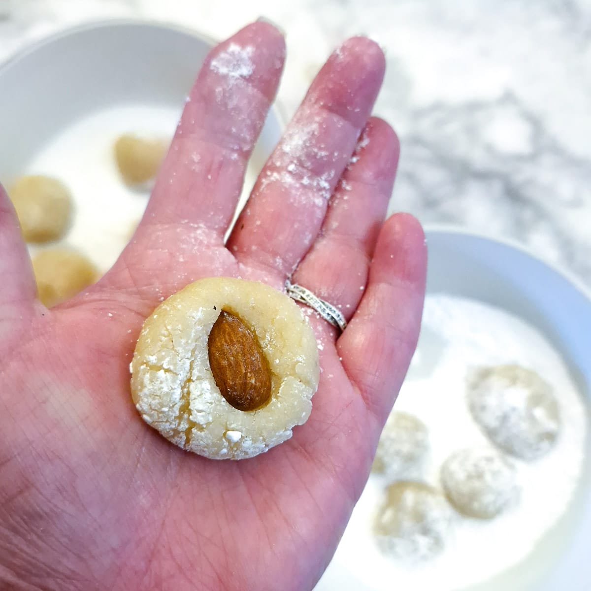An amaretti cookie topped with a whole almond.
