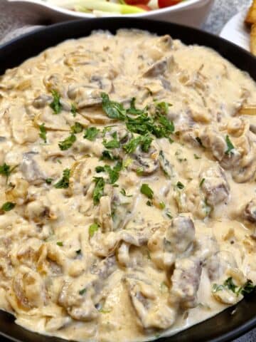 Close up of a dish of creamy beef and mushroom stroganoff.