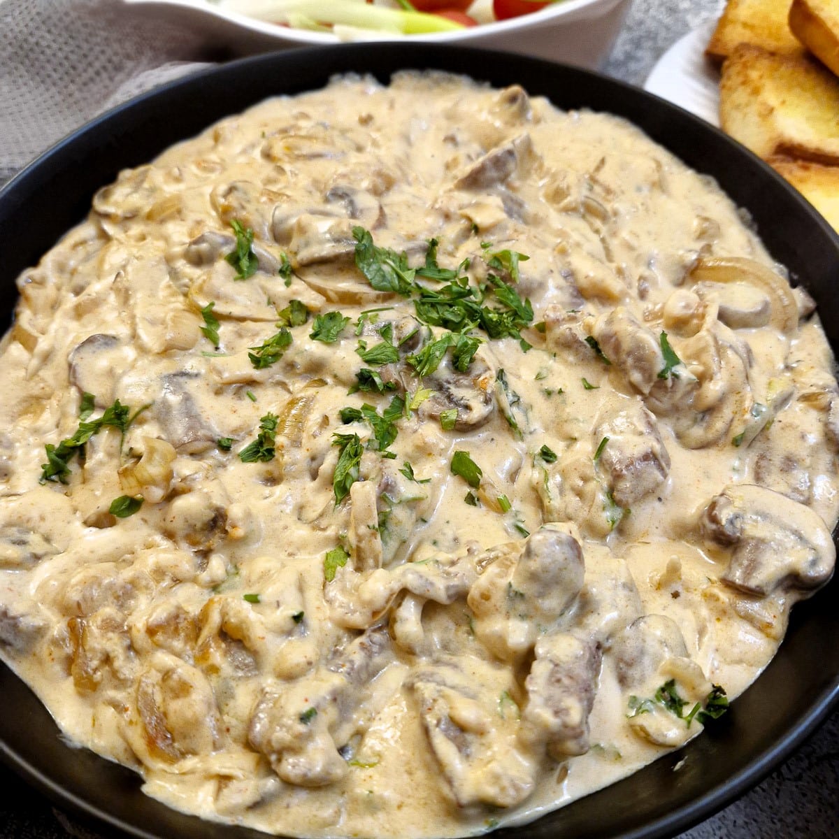 Close up of a dish of creamy beef and mushroom stroganoff.