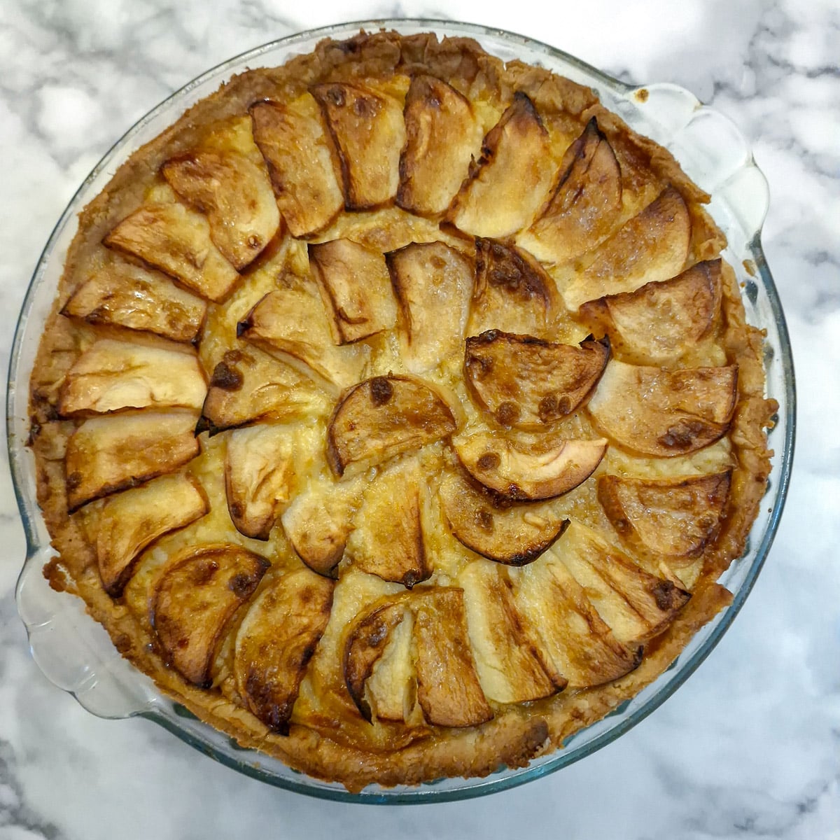 A baked Canterbury tart in a glass pie dish.