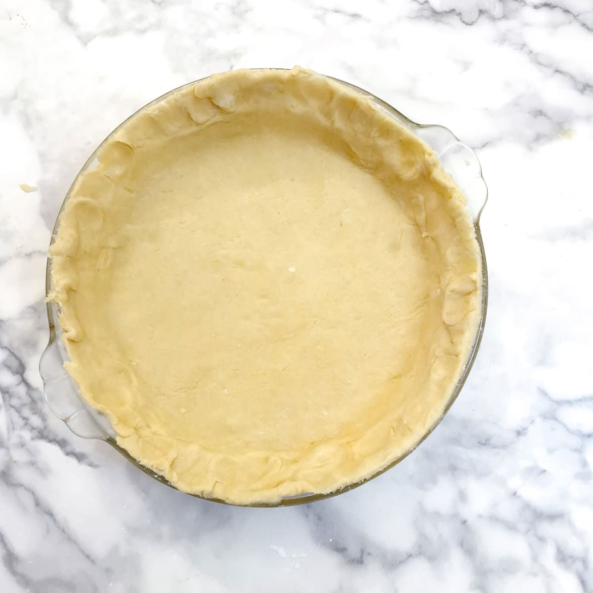 Pastry lined in a pie dish.