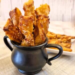 Cheese straws in black jug.