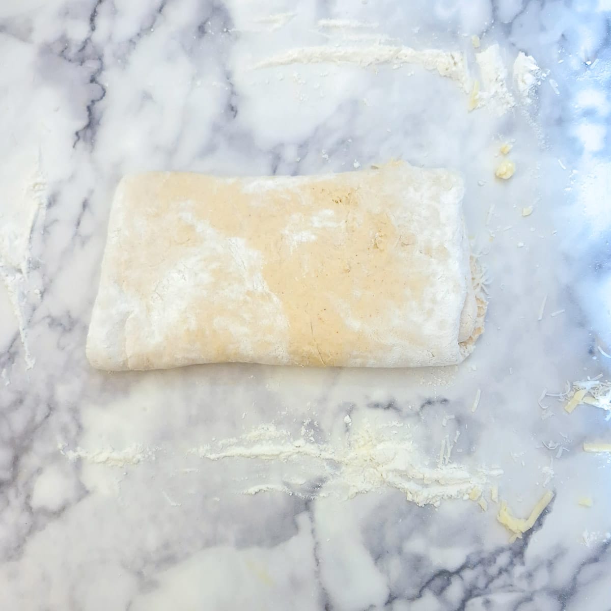 Pastry folded in three to enclose the parmesan cheese.