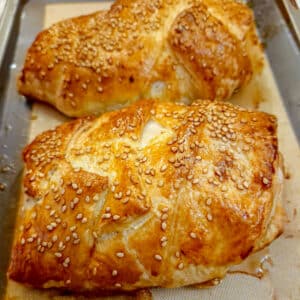 Golden puff-pastry encasing mushroom stuffed chicken breasts.