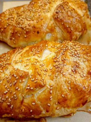 Golden puff-pastry encasing mushroom stuffed chicken breasts.