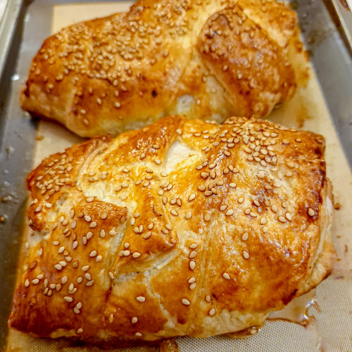 Golden puff-pastry encasing mushroom stuffed chicken breasts.