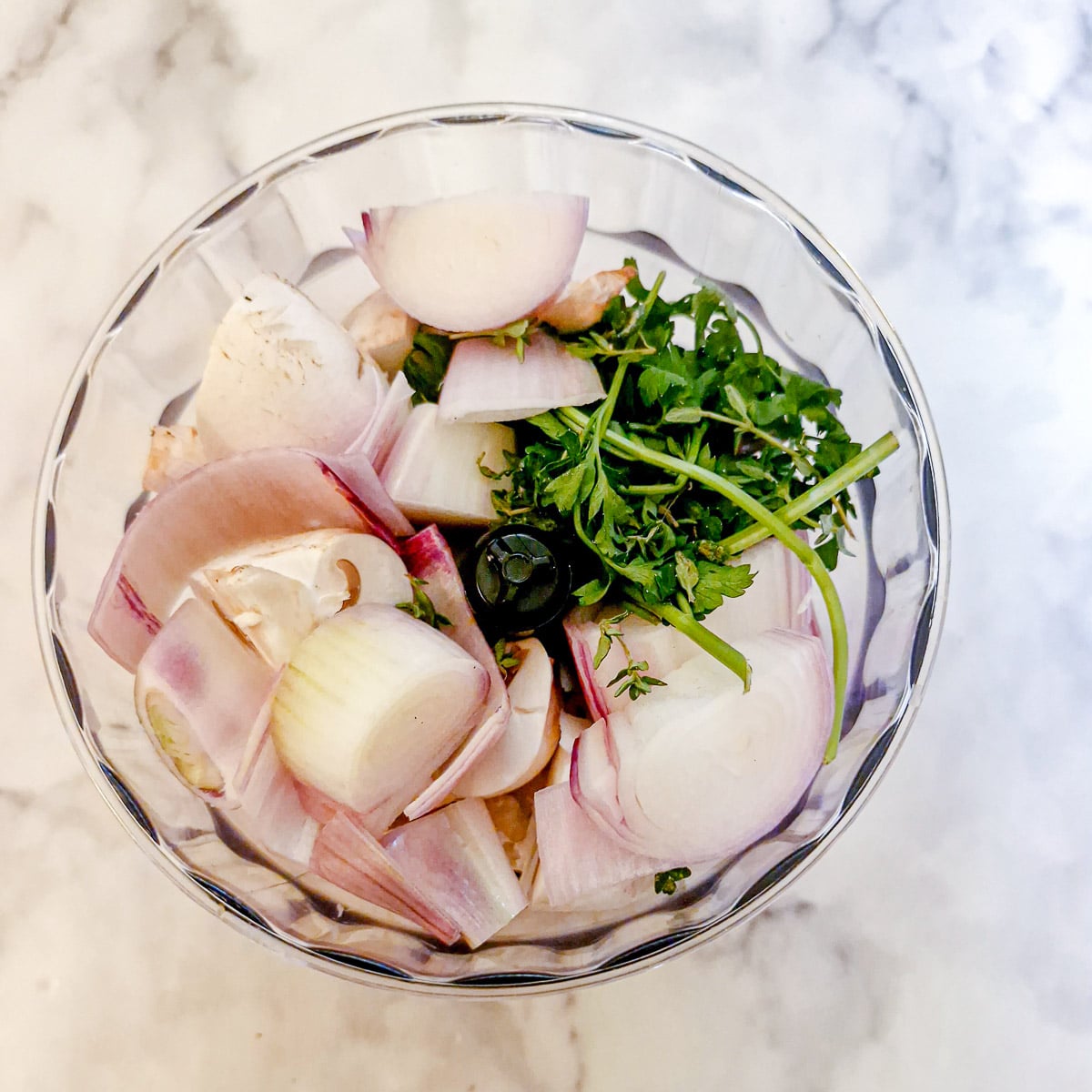 Mushrooms, shallots and herbs in a food processor.