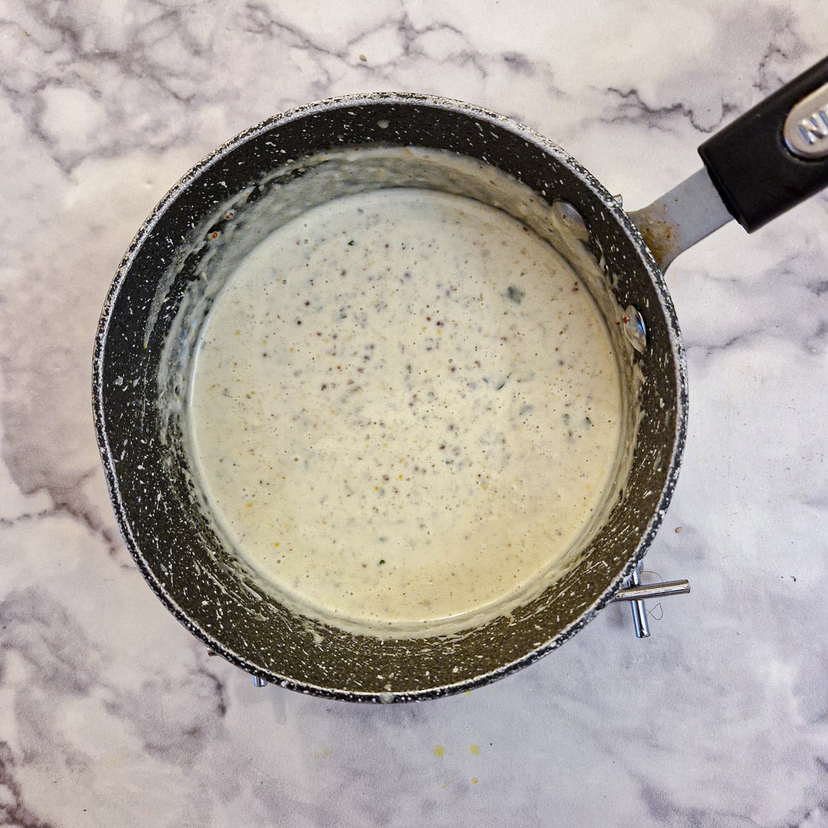 A saucepan of mustard sauce.