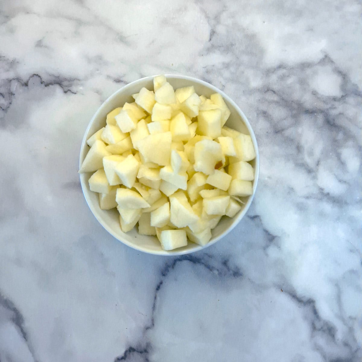 A bowl of finely chopped apples.