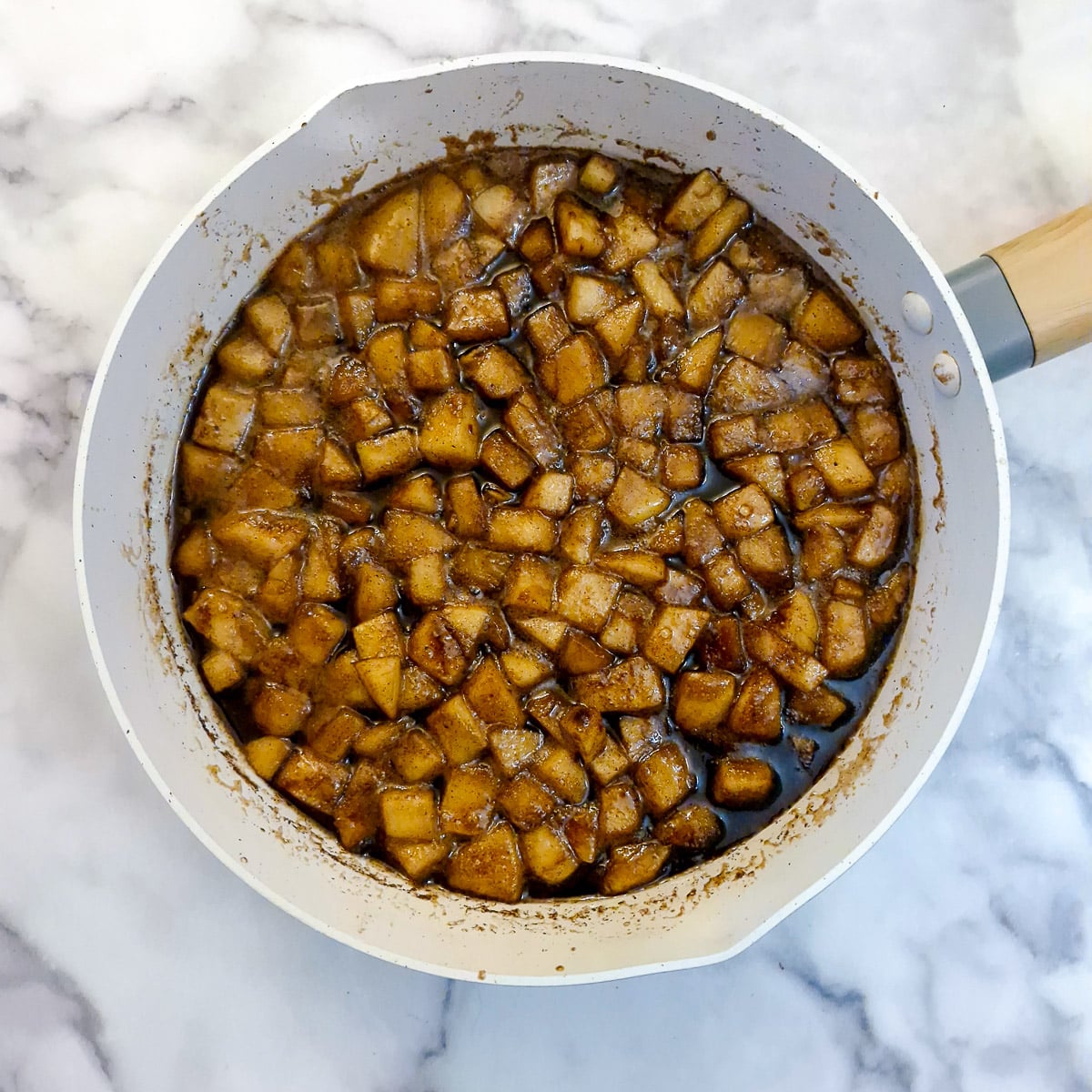 Chopped apples stewing in melted brown sugar and butter.