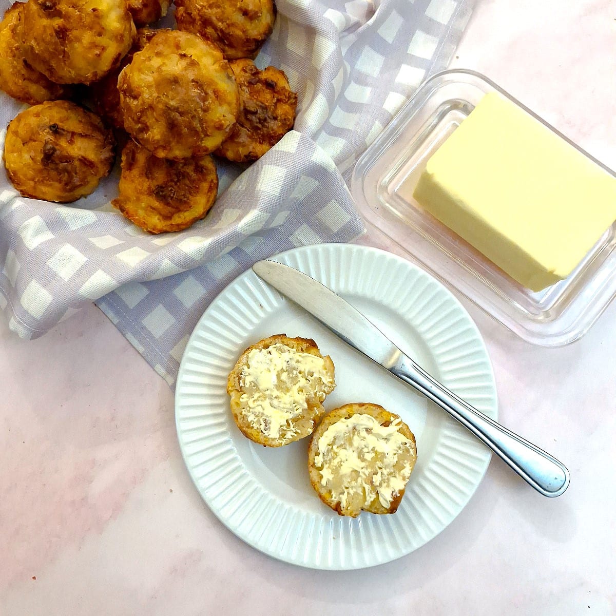 A cornbread muffin cut in half and spread with butter.