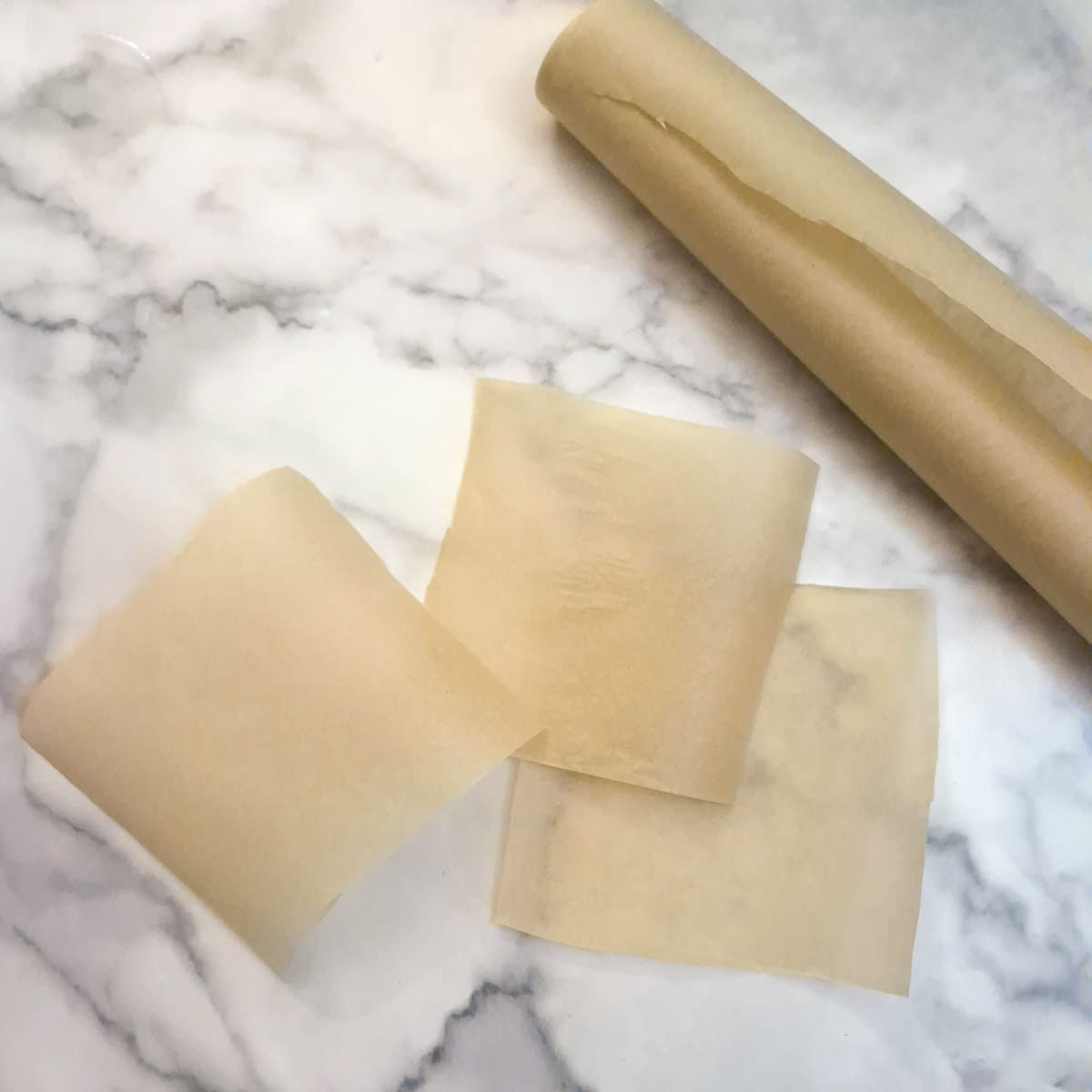Parchment paper cut into 4-inch squares.