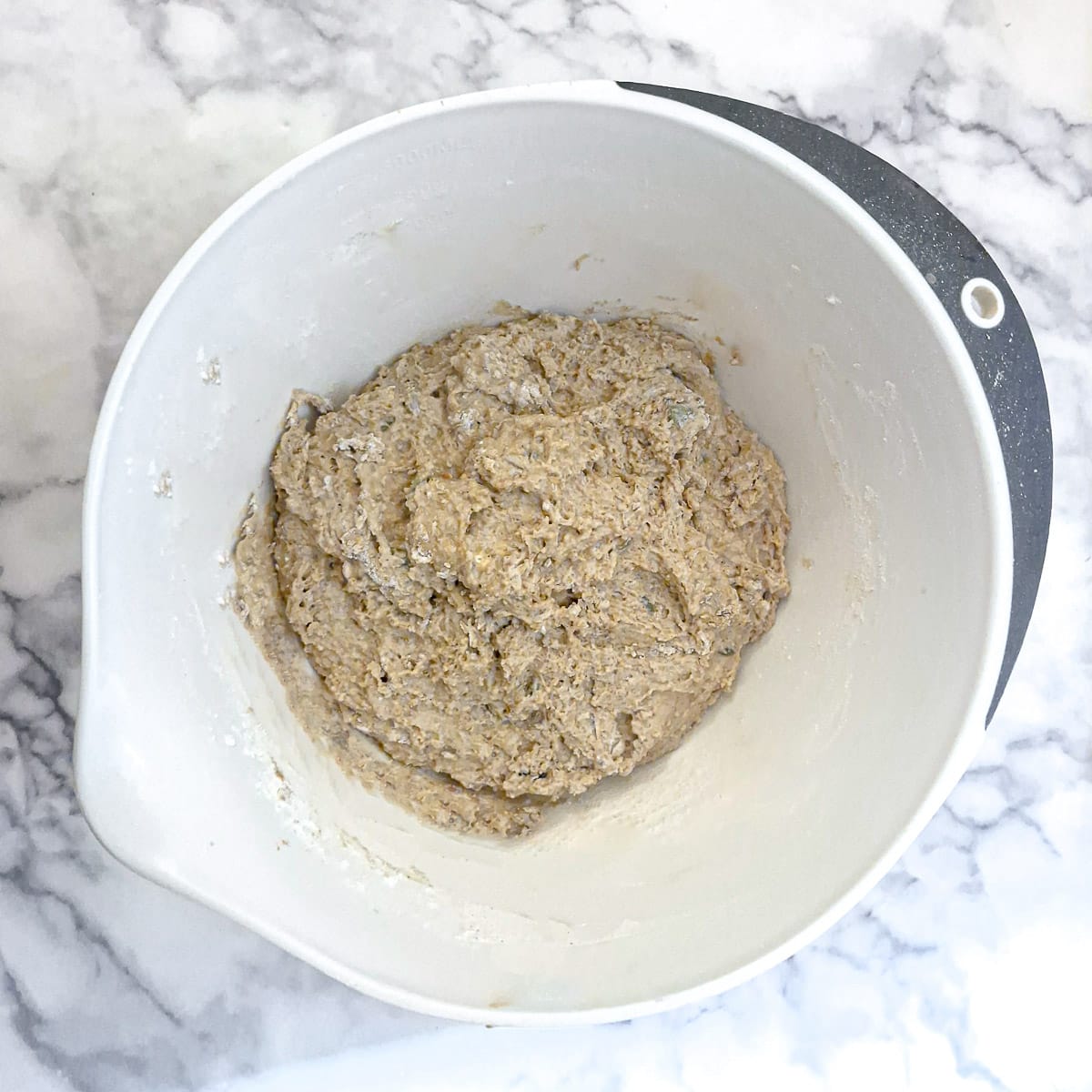 A mixed ball of soda bread dough in a mixing bowl.