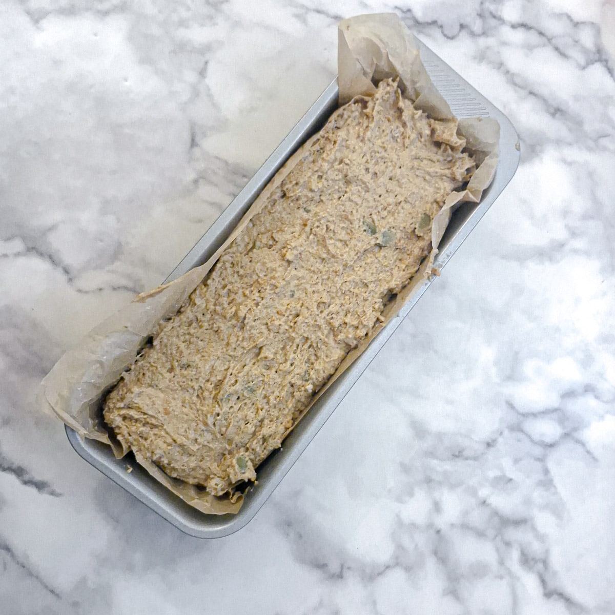 Unbaked soda bread dough in a baking tin.