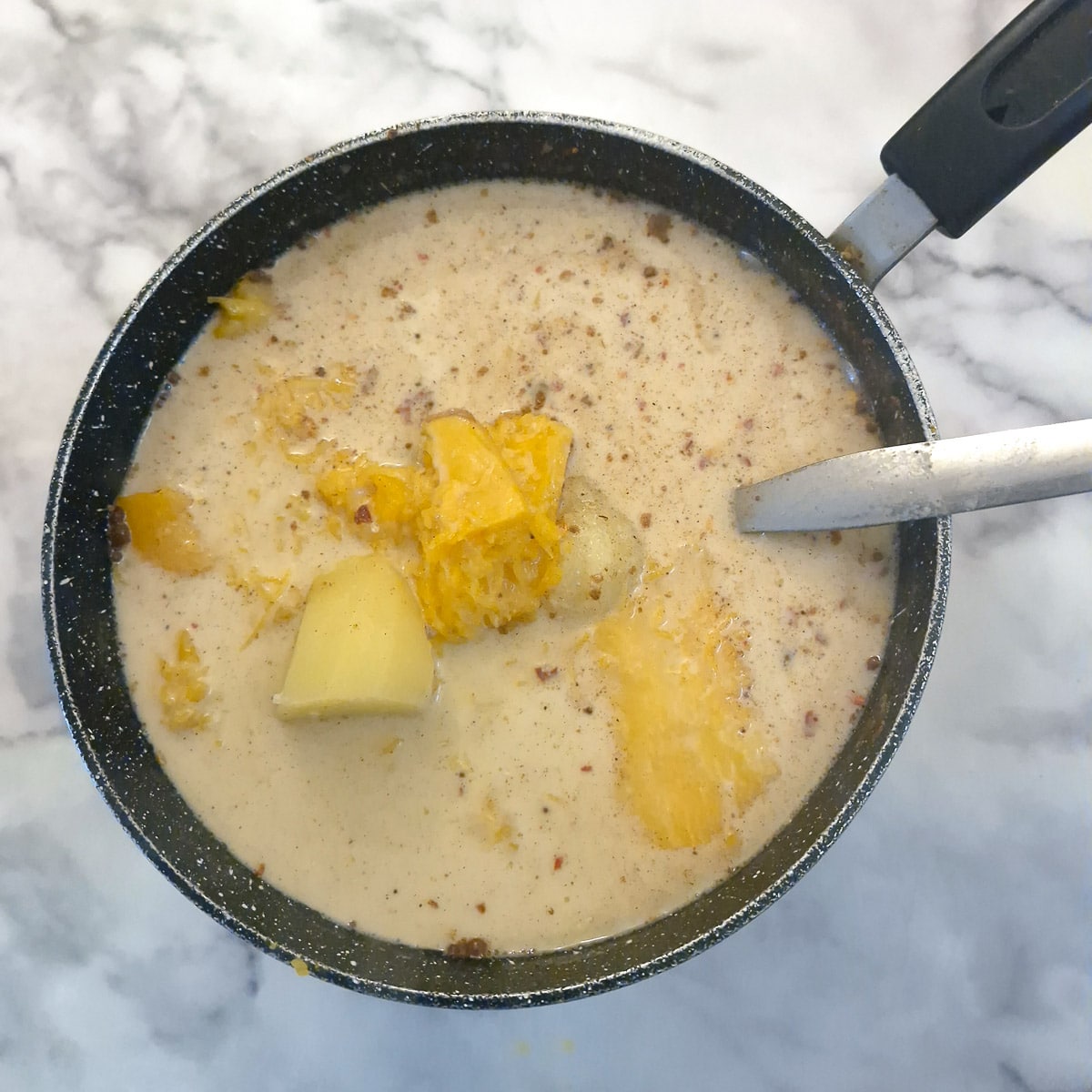 Uncooked butternut soup in a saucepan.