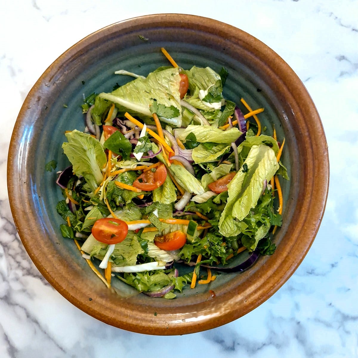 Green salad dressed with Thai dressing.
