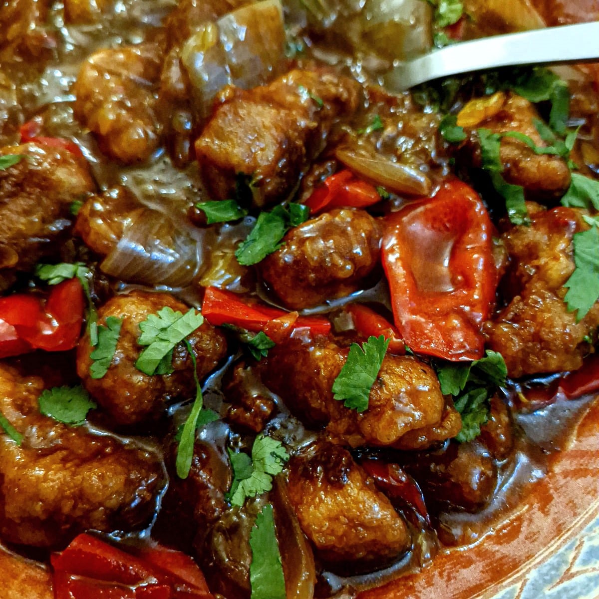 Close up of orange pork stir fry.