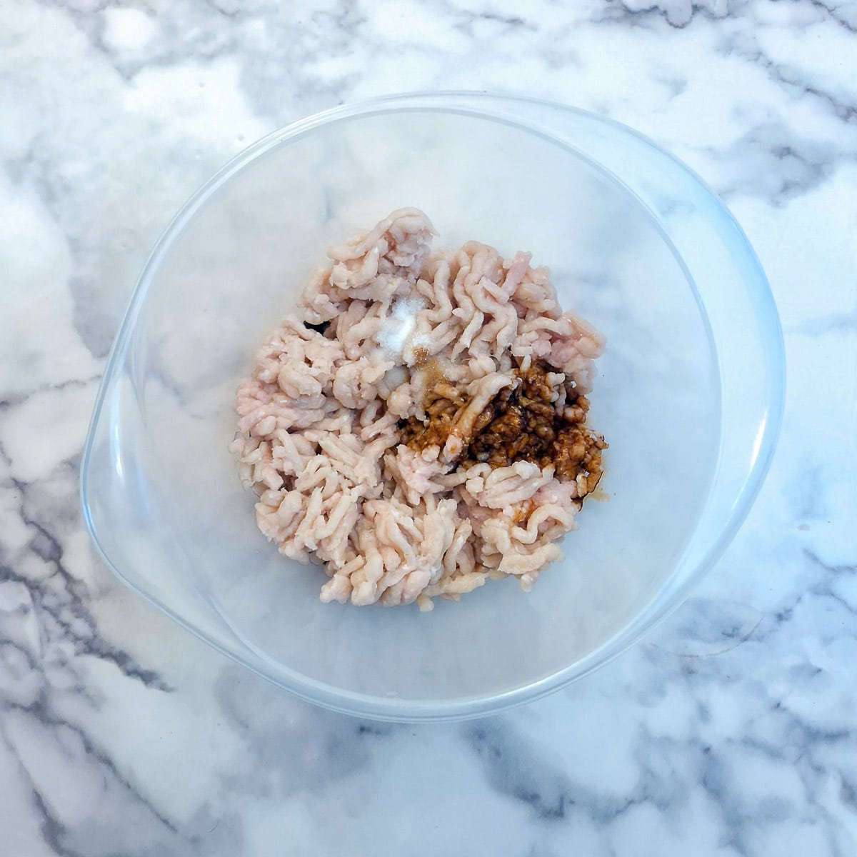 Ground chicken, soy sauce and sherry in a mixing bowl.