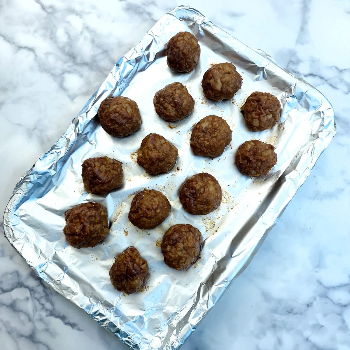 Cooked meatballs on a baking tray