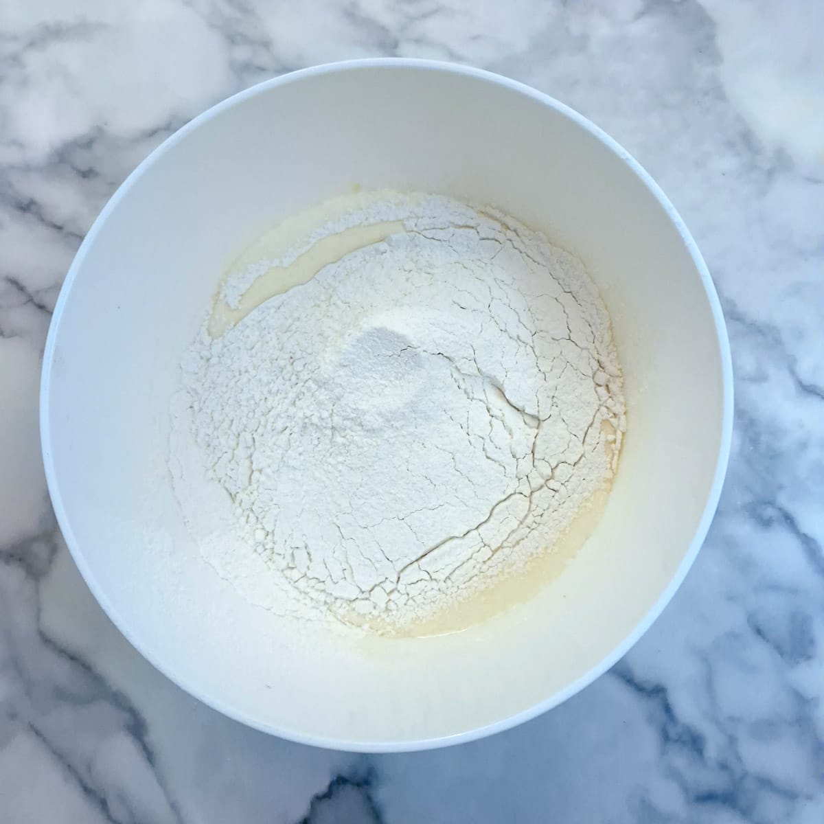 Flour sifted into the eggs and sugar.