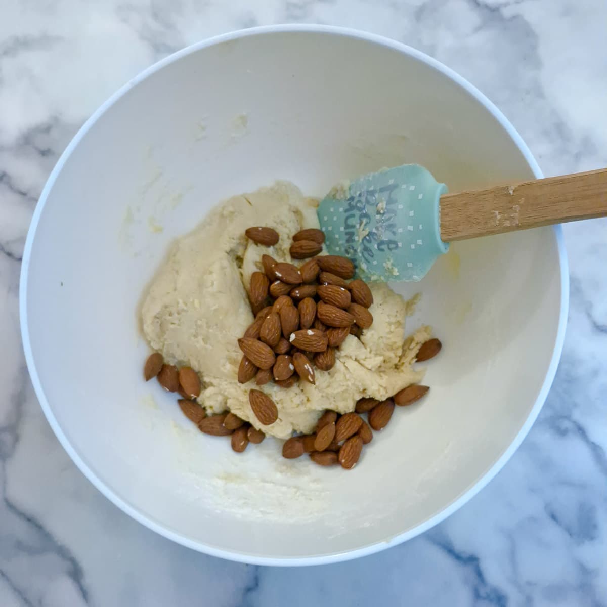 Whole almonds added to the mixing bowl.