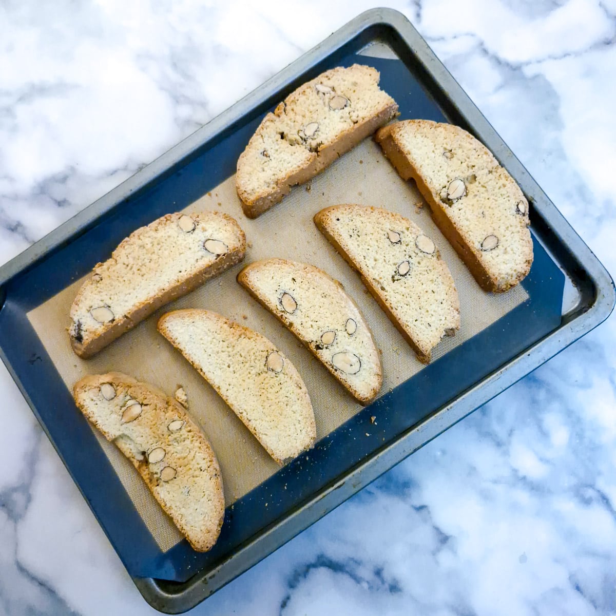 Dried biscotti on a baking tray.