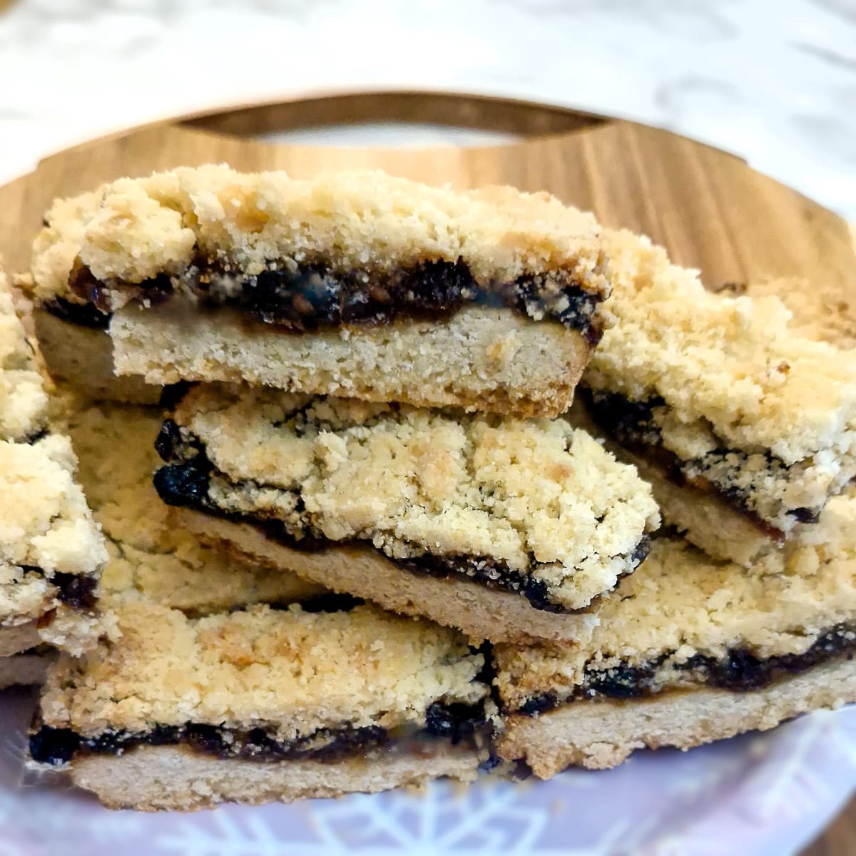 A pile of mince pie slices on a plate.
