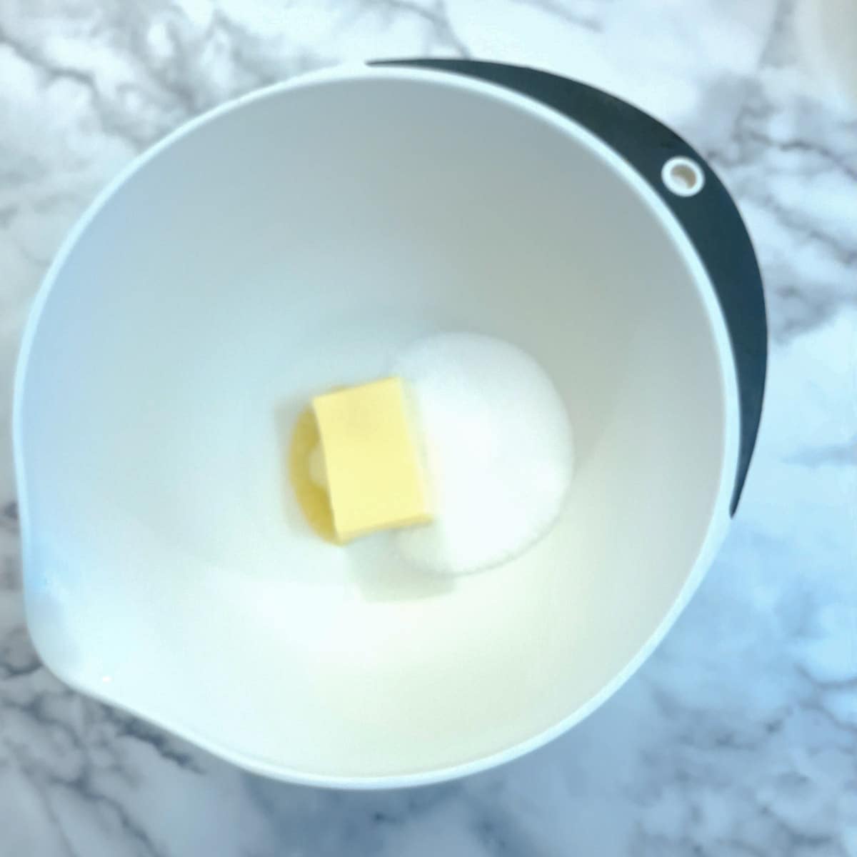 Butter and sugar in a mixing bowl..