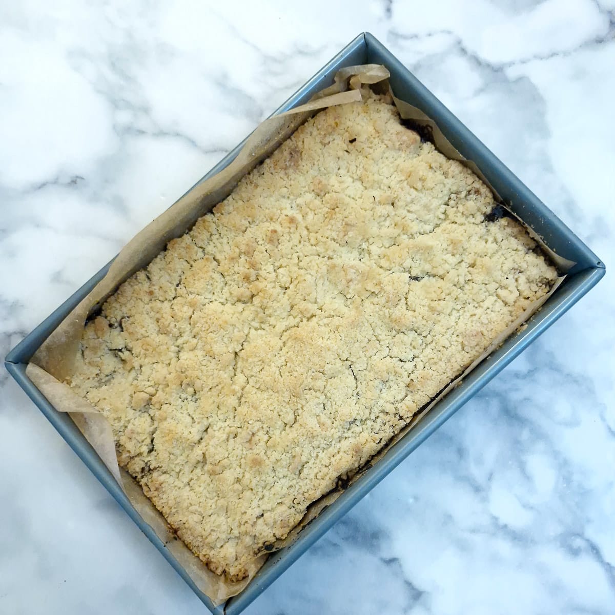 Baked mince pie crumble in a baking tray.