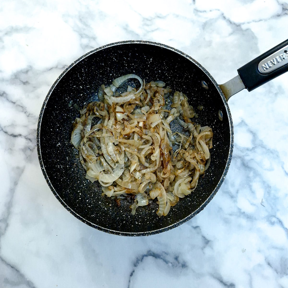 Caramelised onions in a frying pan,