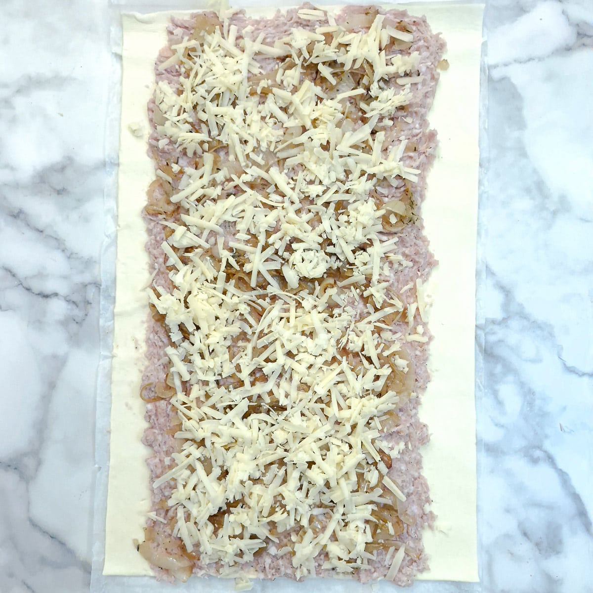 Grated cheese added to the sausage filling.