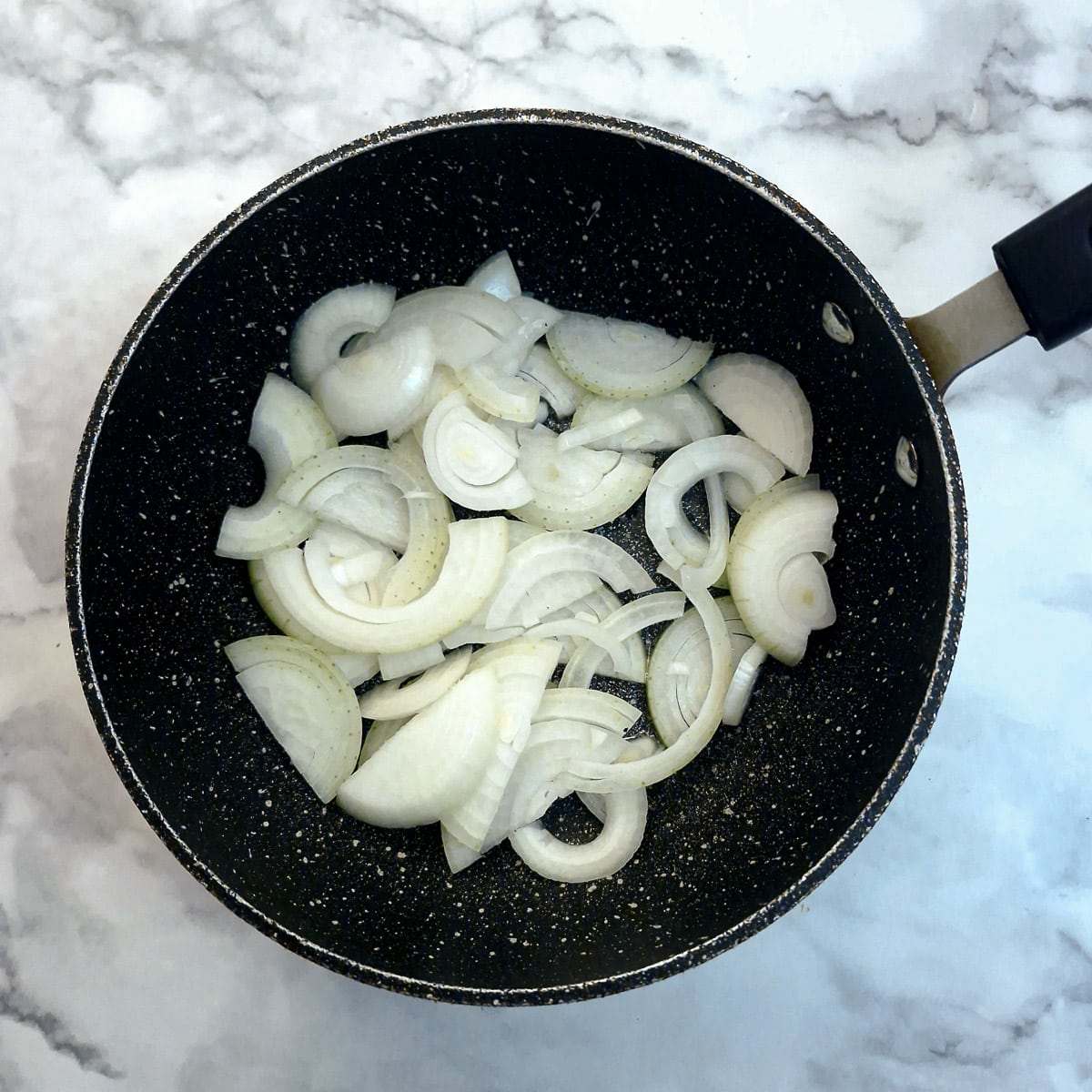 Sliced onions in a pan.