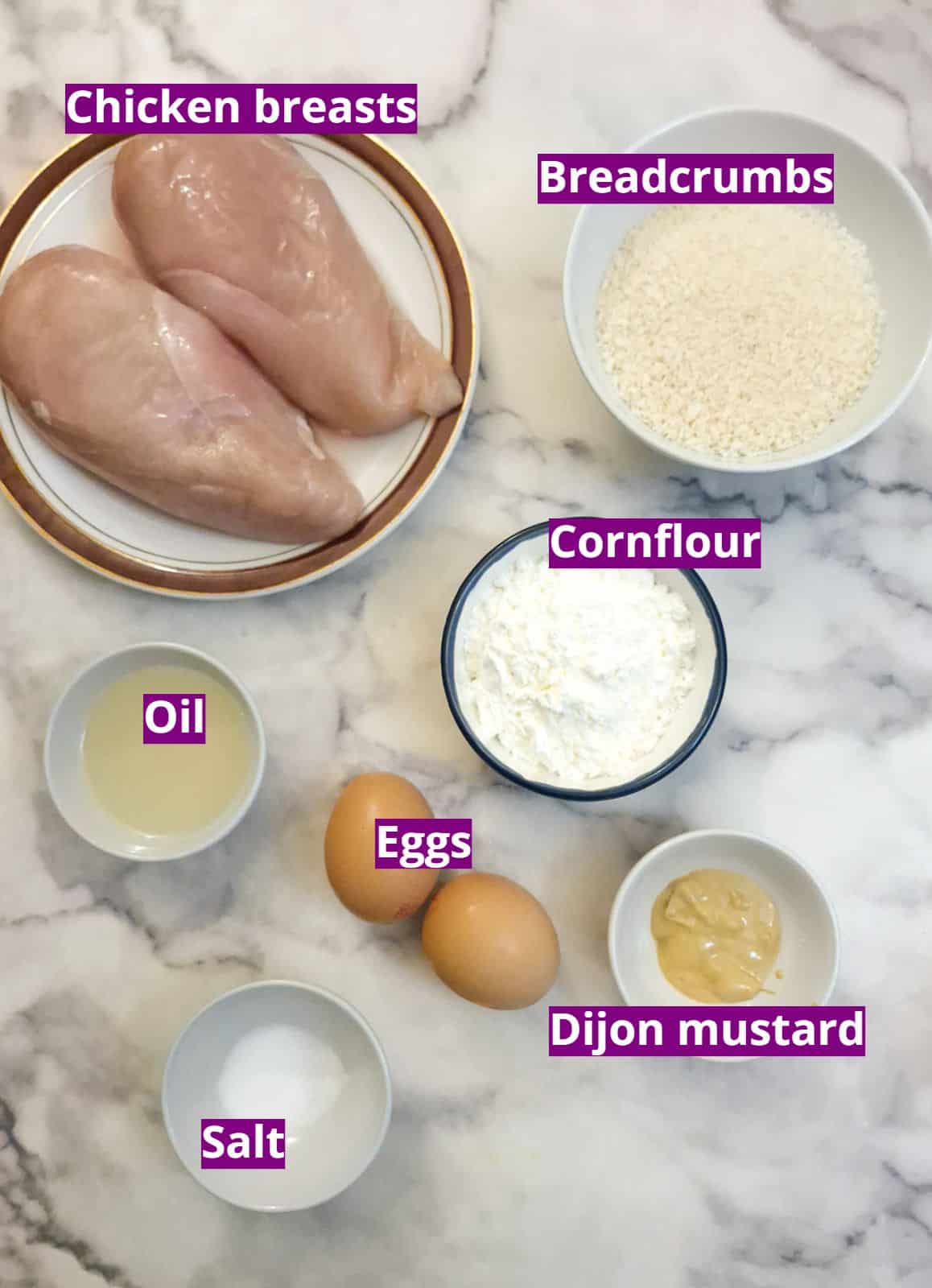 Ingredients for making crumbed chicken schnitzels.