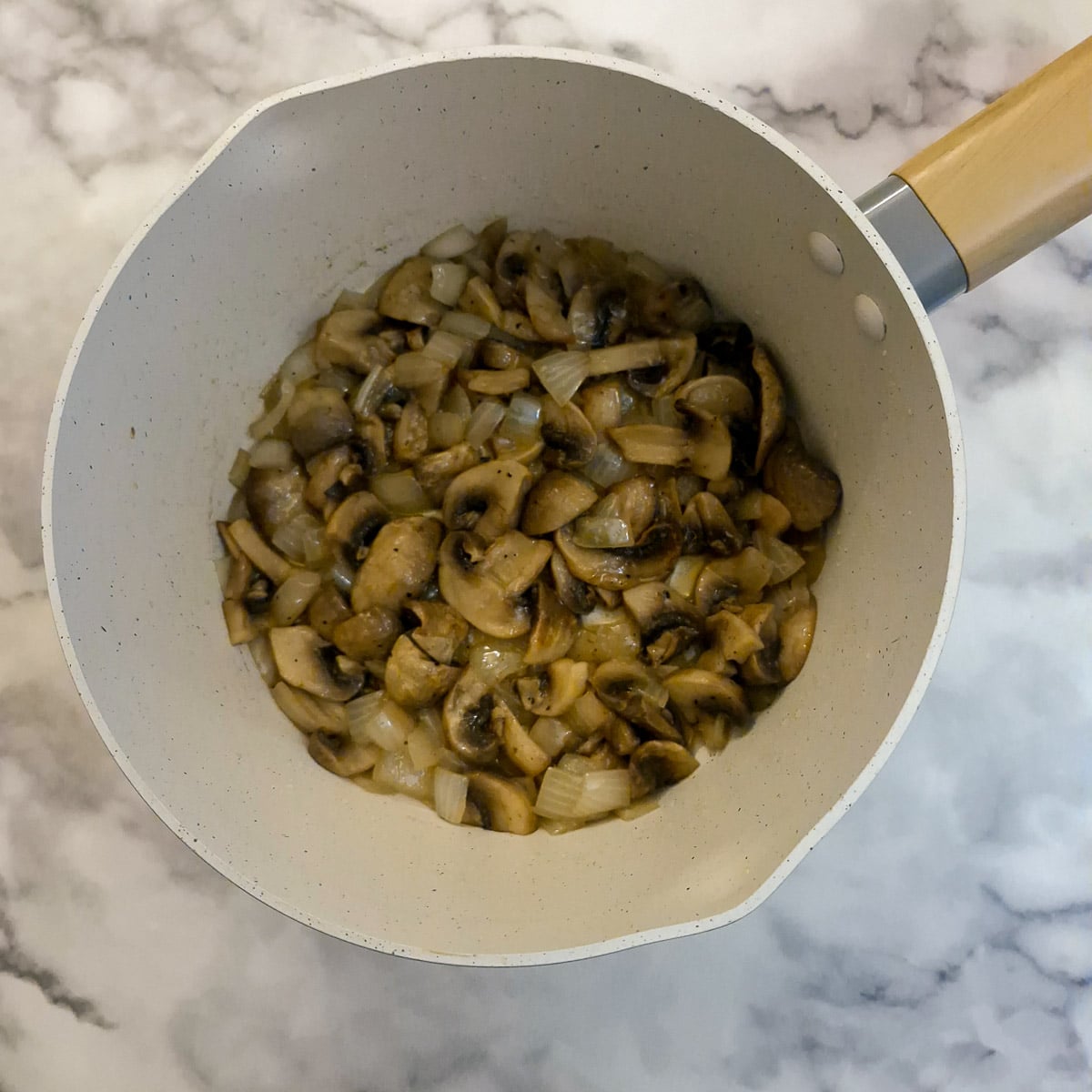 Mushrooms added to sauteed onions.