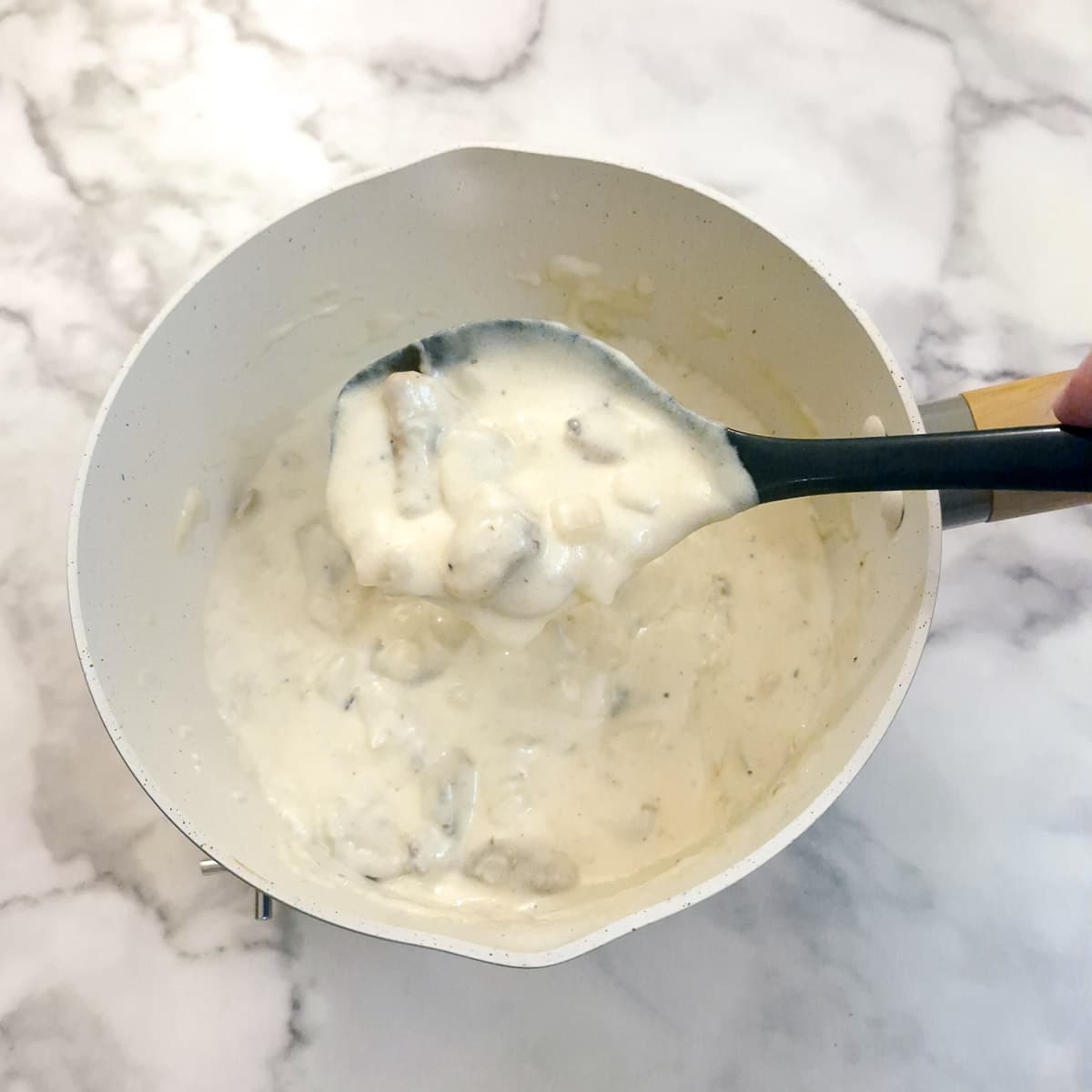 A saucepan of thickened mushroom sauce.