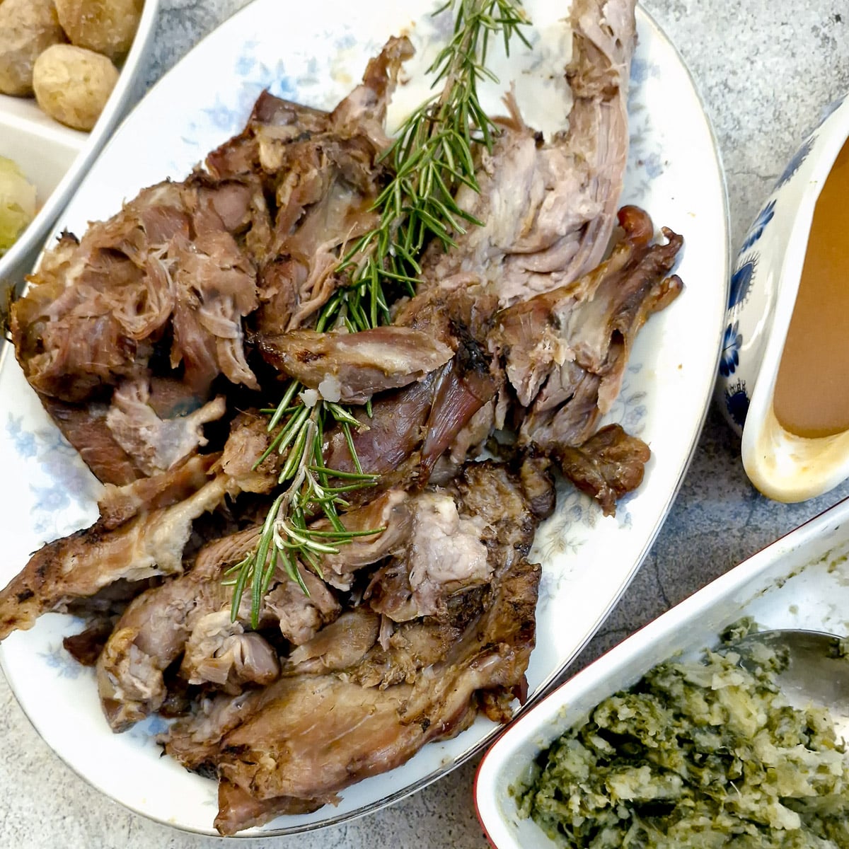 Slow-roasted lamb shoulder on a serving platter.