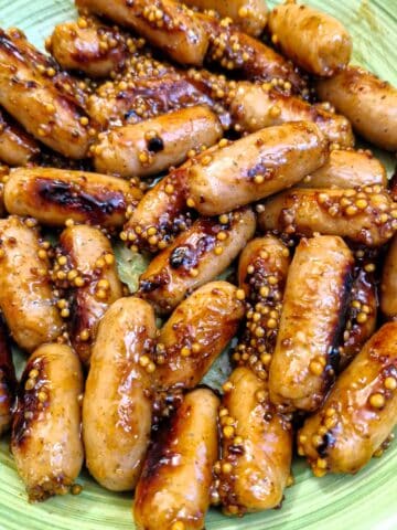 Close up of sticky cocktail sausages.